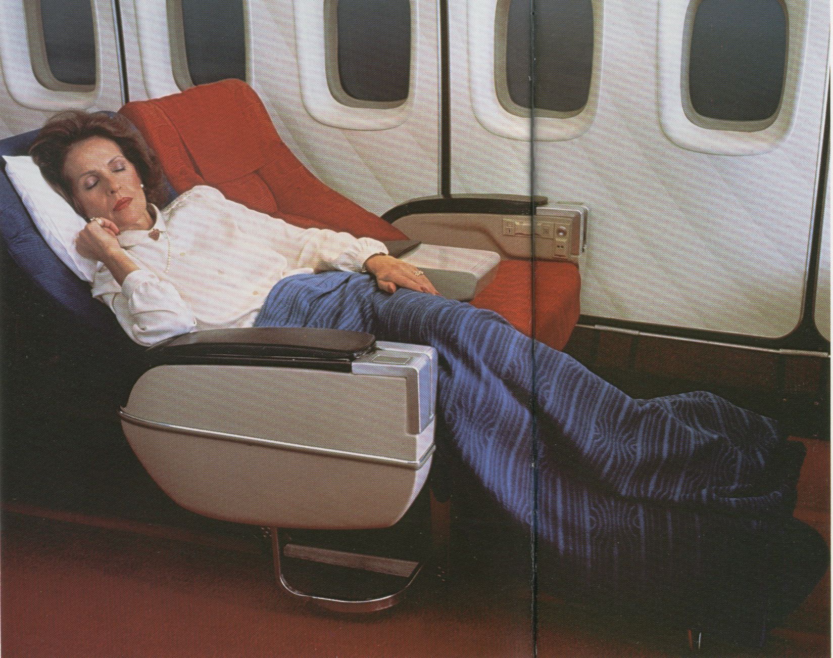 1981 A Pan Am customer slumbers in a Sleeperette First Class seat on a Pan Am Boeing 747SP.